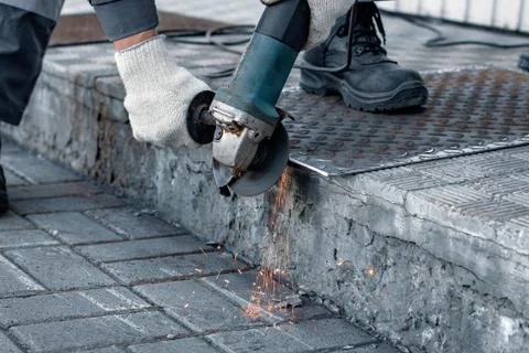 Processing of metal sheet with an angle-grinding tool Stock Photos