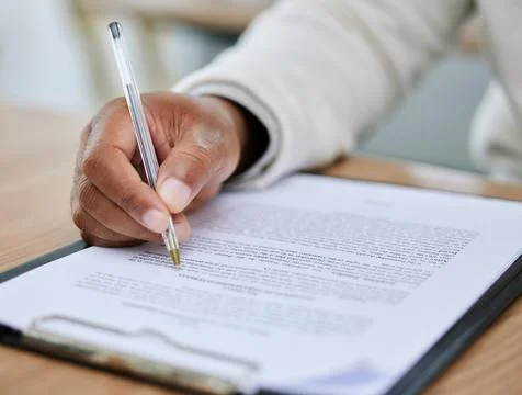 Processing a new application. Closeup shot of an unrecognisable man going 库存照片