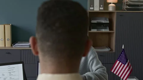 Processing Officer Taking Documents from Girl Applying for Tourist Visa Stock Footage 311028883