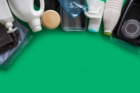 Processing plastic concept. Plastic containers on the green Stock Photos