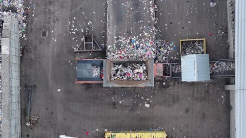 Processing plastic waste at a recycling facility in an industrial setting Stock Footage 338428100