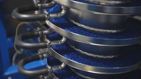 Processing of polymeric materials. Moving blue granules in production. Technolog Stock Footage 124407667