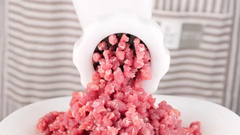 Processing pork or beef meat in minced meat on a hand meat grinder Video stock 231592838