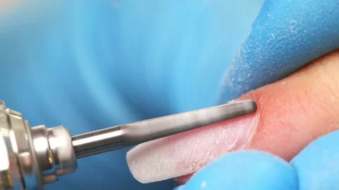 Processing of rough cuticles and lateral folds of nails on hands with a conic Stock Footage 164519995