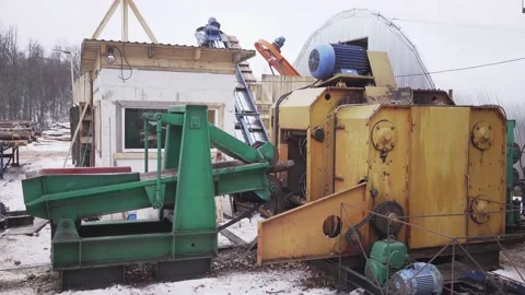 Processing of round timber logs for building wooden house. Removing bark from Stock Footage 130879108
