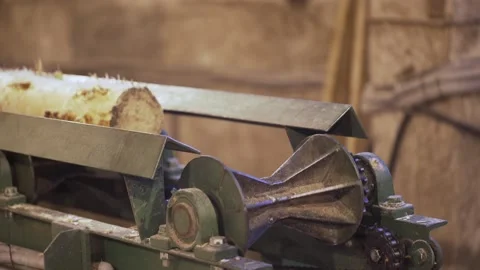 Processing of round timber logs for building wooden house. Removing bark from Stock Footage 130911698