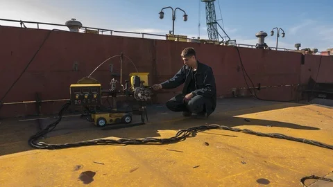Processing of the seam on the hull of the vessel with welding equipment Stock Footage 86783205