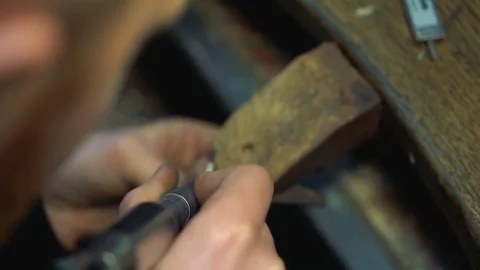 Processing of the silver ring on a wooden table using a jeweler's tool Stock-Footage 73554814