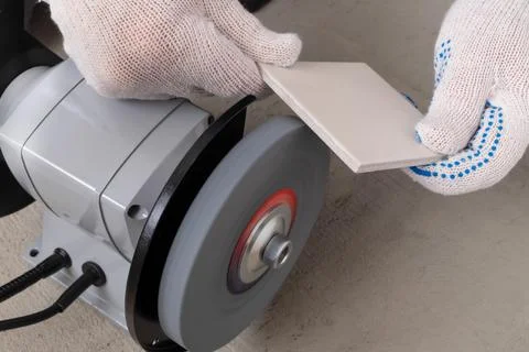 Processing tile or porcelain tiles with a grinder. Stock Photos
