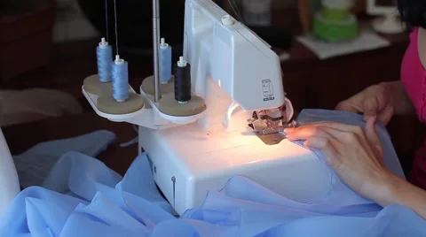 Processing tissue overlock. Women's hands. Start. Sews close-up Stock Footage 67229558