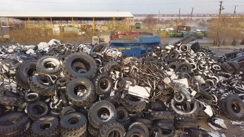 Processing of Wastes. The truck crane loads old tires into the shredder for Stock Footage 87159804