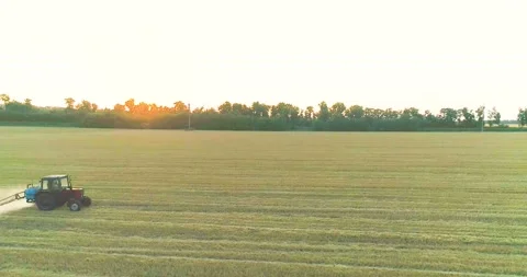 Processing a wheat field with pesticides. View from a drone. Tractor treats Stock Footage 164726430