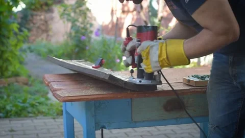 Processing the wood with Router outside in the yard Stock Footage 253323265