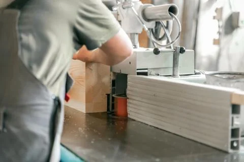 Processing of wooden beams on the machine. Stock Photos