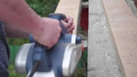 Processing of wooden boards with a tool. Man-Builder, working on a workbench Video stock 91898062
