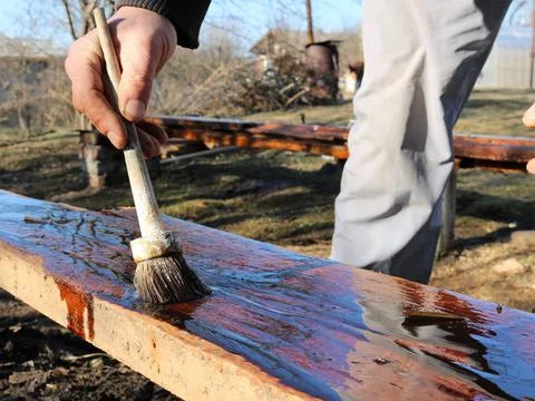 Processing of wooden material with technical oil Stock Photos