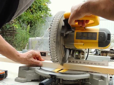 Processing of wooden planks on the end-cutting machine Stock Photos