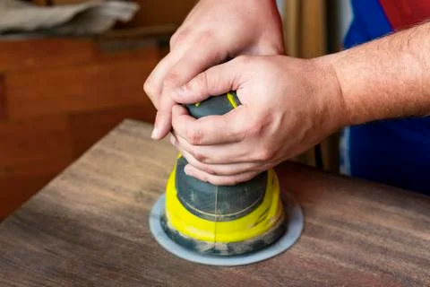 Processing of a wooden surface by the grinding machine. Stock Photos