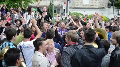A procession of partying, shouting and laughing students on the street Stock Footage 49786844