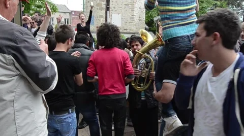 A procession of partying, shouting and laughing students on the street Stock Footage 49786930