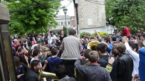 A procession of partying, shouting and laughing students on the street Stock Footage 49787134