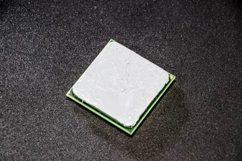 The processor of the computer with the thermal paste applied on it. Details o Stock Photos