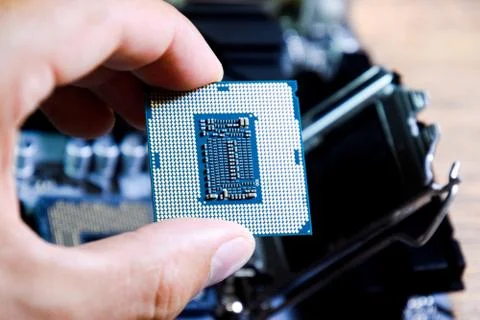 The processor is a desktop computer in hand. Inspect the CPU contacts before Stock Photos