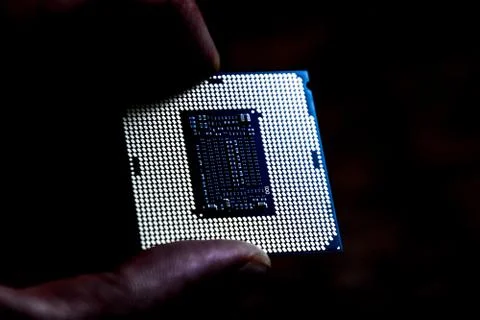 The processor is a desktop computer in hand. Inspect the CPU contacts before Stock Photos