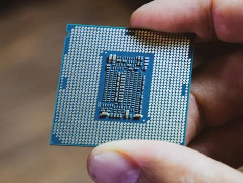 The processor is a desktop computer in hand. Inspect the CPU contacts before  写真素材