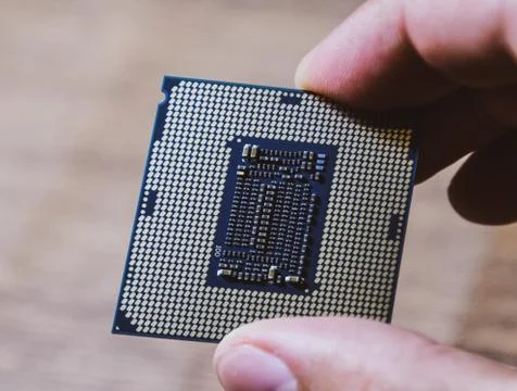 The processor is a desktop computer in hand. Inspect the CPU contacts before  写真素材