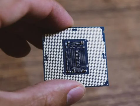 The processor is a desktop computer in hand. Inspect the CPU contacts before  写真素材