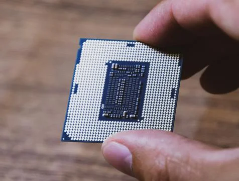 The processor is a desktop computer in hand. Inspect the CPU contacts before  写真素材