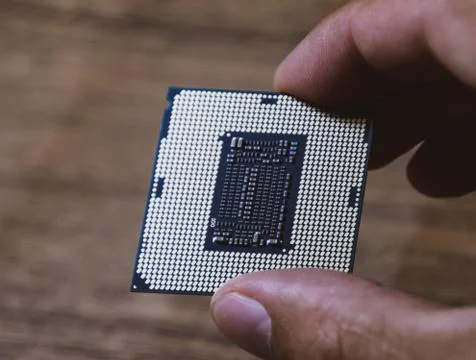 The processor is a desktop computer in hand. Inspect the CPU contacts before  写真素材