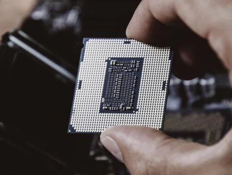 The processor is a desktop computer in hand. Inspect the CPU contacts before  写真素材