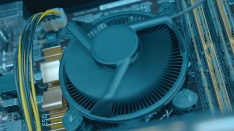 The processor fan on the computer motherboard and two video card fans spin  Stock Footage 259688271