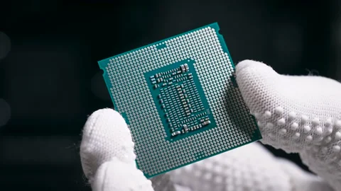 The processor is in the hands. A gloved hand holds the CPU. Stock Footage 148817310