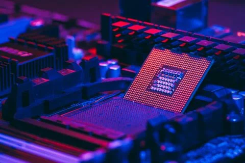 The processor on the motherboard in neon light. Computer parts. Close-up phot Stock Photos