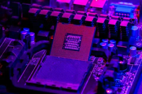 The processor on the motherboard in neon light. Computer parts. Close-up phot 写真素材