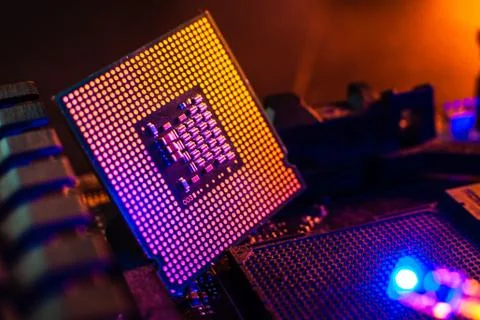 Processor with neon light. Large photo with blue-yellow light on a dark backg Stock Photos