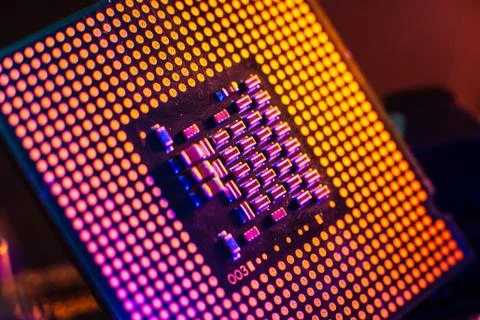 Processor with neon light. Large photo with blue-yellow light on a dark backg Stock Photos