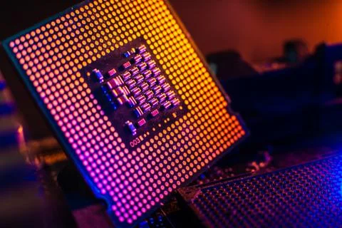 Processor with neon light. Large photo with blue-yellow light on a dark backg Stock Photos