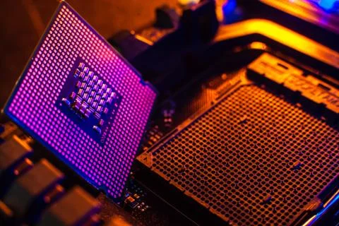 Processor with neon light. Large photo with blue-yellow light on a dark backg Stock Photos