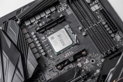 Processor Ryzen 7 2700X against the background of a computer motherboard Asus 스톡 사진