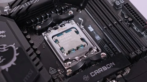 Processor securely installed in motherboard socket, showcasing AMD Ryzen CPU Stock Footage 294796951