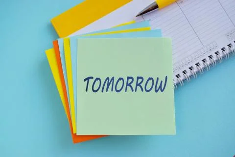 Procrastination, delay and urgency concept. Bad time management. Word TOMRROW Stock Photos