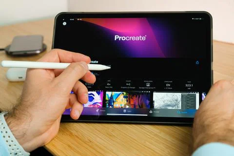Procreate is used with apple pencil on iPad Pro tablet . Man using application Stock Photos
