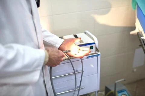 The proctologist checks the instrument before the procedure Stock Photos