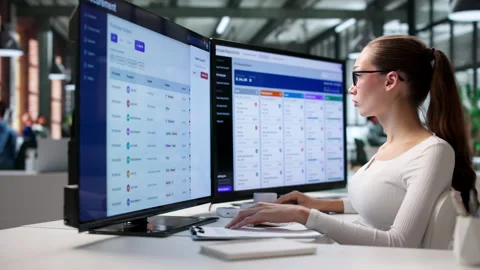 Procurement Manager Carefully Reviews Software Data On Desktop Stock Footage 343888915