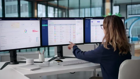 Procurement Manager Reviews Supplier Bids On Computer Vidéo 345854741