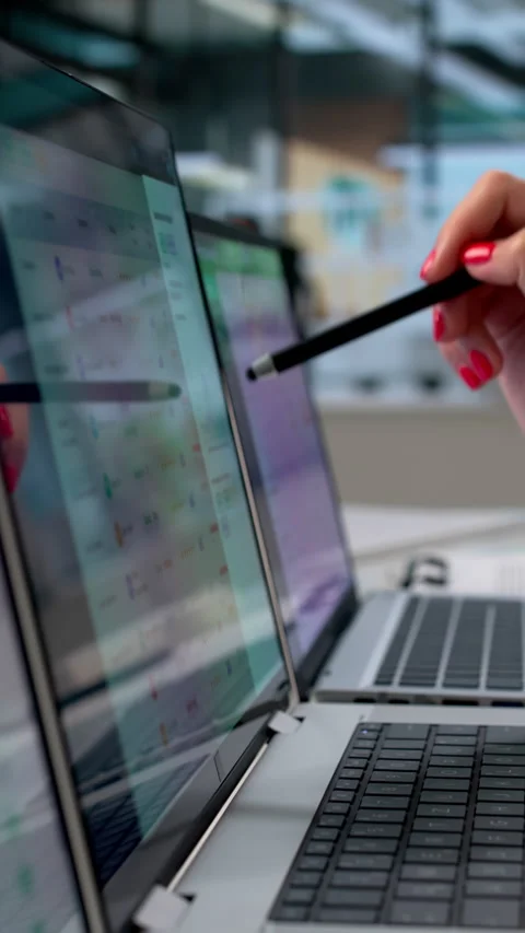 Procurement Manager Using Multiple Computer Screens Analyzing Supplier Data Stock Footage 339903359